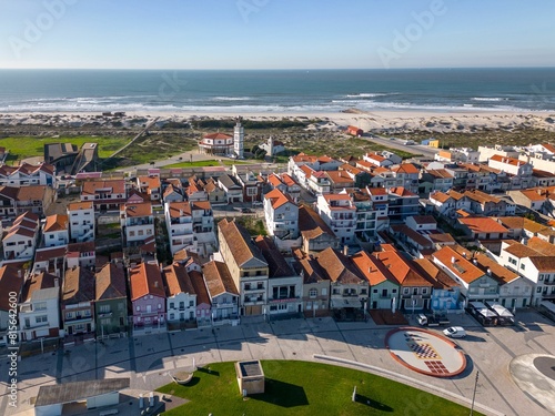 a coastal town, featuring a selection of beachfront houses and a sandy beach, Costa Nova, Portugal photo