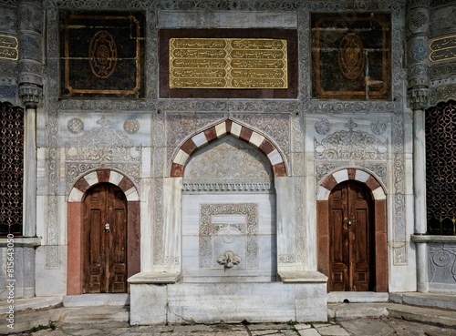 Canvas Print Stone and wood constructed building featuring an archway and ornately carved des