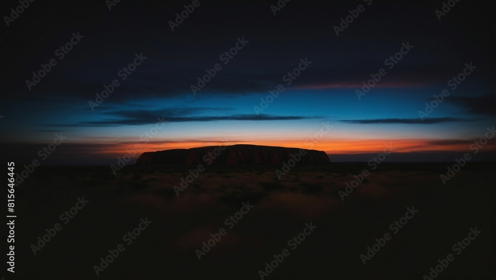 Spectacular twilight sky at Uluru, Australia, with vivid orange and blue hues Spectacular twilight sky at Uluru, Australia, with vivid orange and blue hues