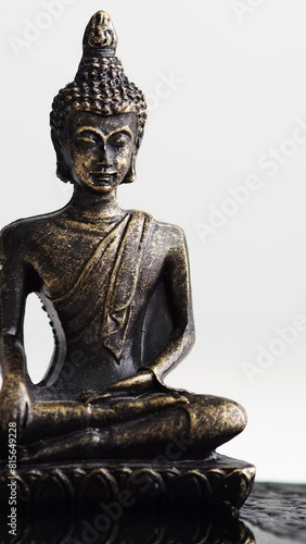 A Buddha statuette on a white background. Storytelling. A symbol of domestic happiness. Spiritual enlightenment, devotion, the path to self. Vesak, Wesak day
