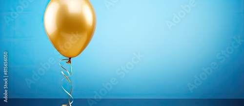 golden yellow foil balloon on blue concrete background number ninety eight Birthday or anniversary card with the inscription 98 Anniversary celebration Banner. copy space available photo