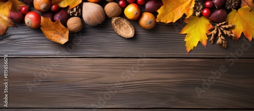 Autumn still life with yellow leaves nuts on a wooden background view from above. copy space available