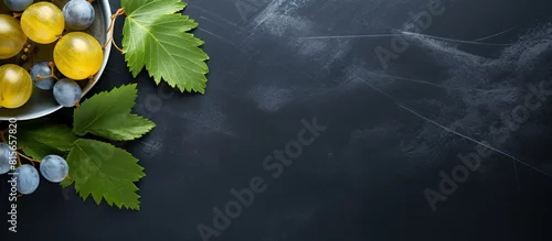 Panel kuchenny z motywem Some organic gooseberries from the garden and a leaf on a blue gray plate and a dark slate background with copy space high angle view from above