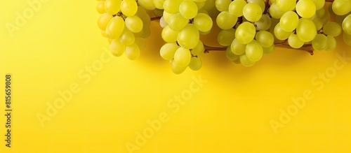 green grapes on yellow background with copy space