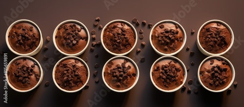 Brownies Brownie cakes topped with melted chocolate and choco chips placed in a cup on a plain background Top view. copy space available