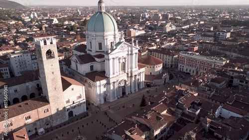 Ascending drone shot of Cathedral of Santa Maria Assunta and Pegol Tower in Brescia, Lombardy, Italy photo