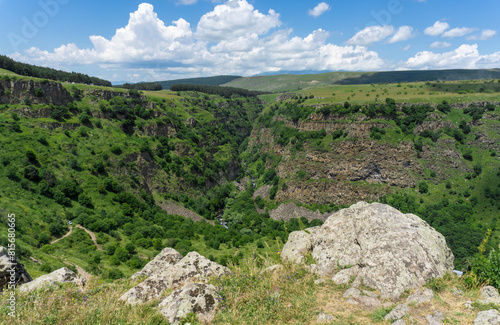 Huge rocks on the edge of a cliff. Blue sky with clouds above the horizon. Tsalka canyon, Georgia photo