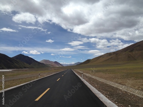 a empty road in the middle of a vast plain area