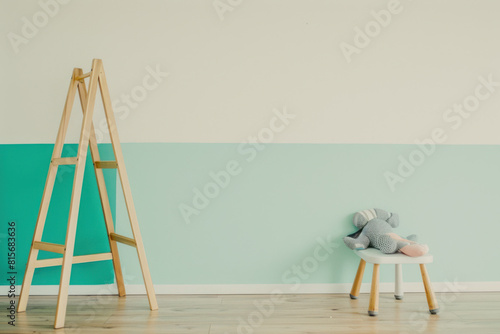 Mockup wall in the children's room, toys and wall green and white colors background, copy space.