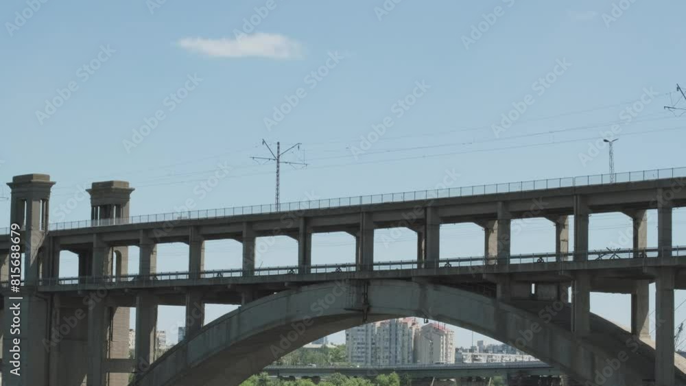Train travelling over the Viaduct in the background on a sunny day. A train from the 70s slowly travels through a two-tier arched bridge with the city in the background. Train travelling over the Viaduct in the background on a sunny day. A train from the 70s slowly travels through a two-tier arched bridge with the city in the background.