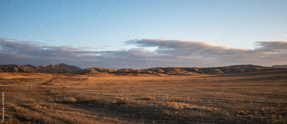 Sunrise on an empty valley amazing hilly landscape. Colorful grassy and hilly natural landscape in autumn. Beautiful autumn scenery in Inner Mongolia, China.