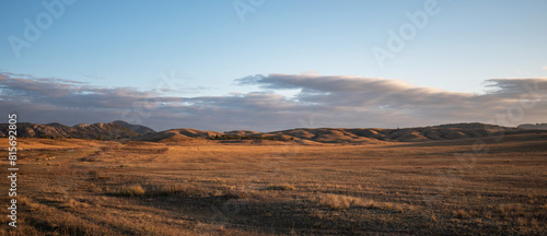 Sunrise on an empty valley amazing hilly landscape. Colorful grassy and hilly natural landscape in autumn. Beautiful autumn scenery in Inner Mongolia, China.