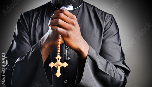 Extreme close-up of priest praying holding a rosary and a wooden religious cross against on a dark-black background. Religious symbol of Christianity or prayer. Generative Ai. photo