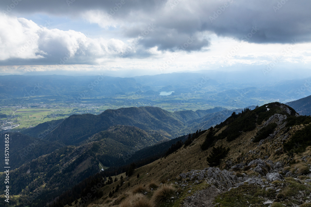 Fototapeta premium Begunjščica panorama of mountain trekking to the highest peak. View of the Alps, climbing with via ferrata. Distant view of Lake Bled from above. Sports holidays, life of adventure in the countryside
