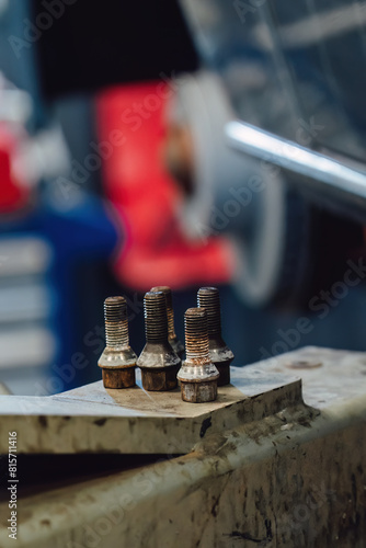 Unscrewed rusty wheel bolts in a car service center