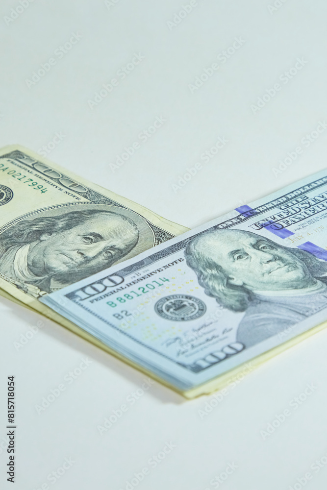 Stacks of hundred-dollar bills lie at an angle on top of each other, vertical shot Stacks of hundred-dollar bills lie at an angle on top of each other, vertical shot