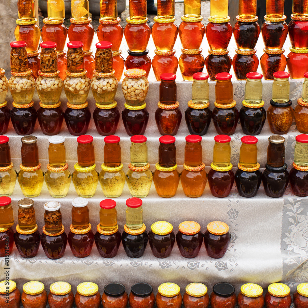 Various honey in glass jars on the shelves. Street trading in tourist areas. Various honey in glass jars on the shelves. Street trading in tourist areas.