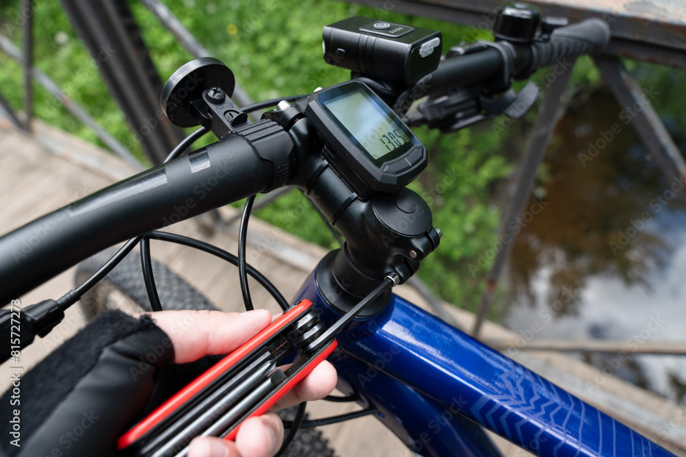Setting up and adjusting a new bicycle with the hexagon key. Mountain bike rider customizes the bike to fit his or her needs. Setting up and adjusting a new bicycle with the hexagon key. Mountain bike rider customizes the bike to fit his or her needs.
