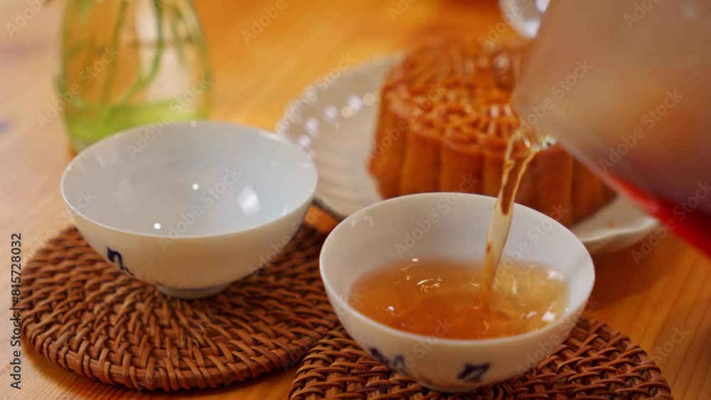 Pouring out Chinese Puer tea into tea cups
