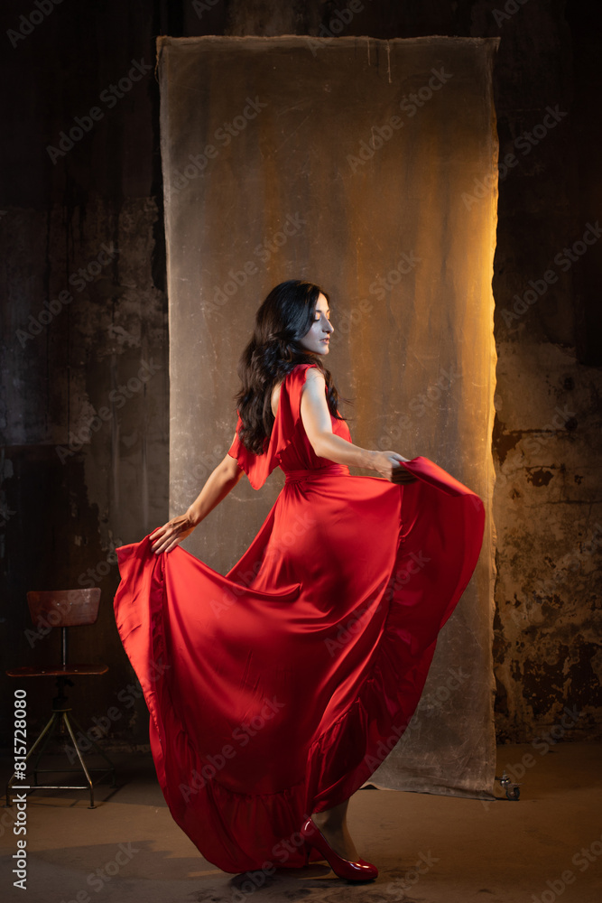 femme fatale in red dress. An attractive brunette in an elegant dress femme fatale in red dress. An attractive brunette in an elegant dress