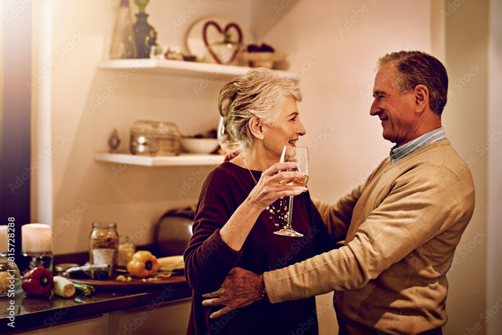Senior couple, wine and dance in the kitchen to celebrate anniversary date, dinner or lunch at home. Happy, cheers and elderly man or woman bonding, together for love and marriage for happiness Senior couple, wine and dance in the kitchen to celebrate anniversary date, dinner or lunch at home. Happy, cheers and elderly man or woman bonding, together for love and marriage for happiness
