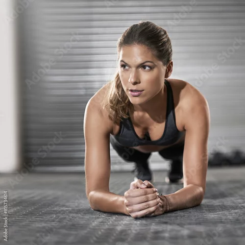 Obraz Endurance, training and woman with plank in gym for core strength, muscle exercise and challenge. Female person, thinking and athlete on ground in health club for fitness, abs workout and balance