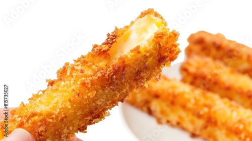 Cheese stick with breadcrumbs held in hand against a white background