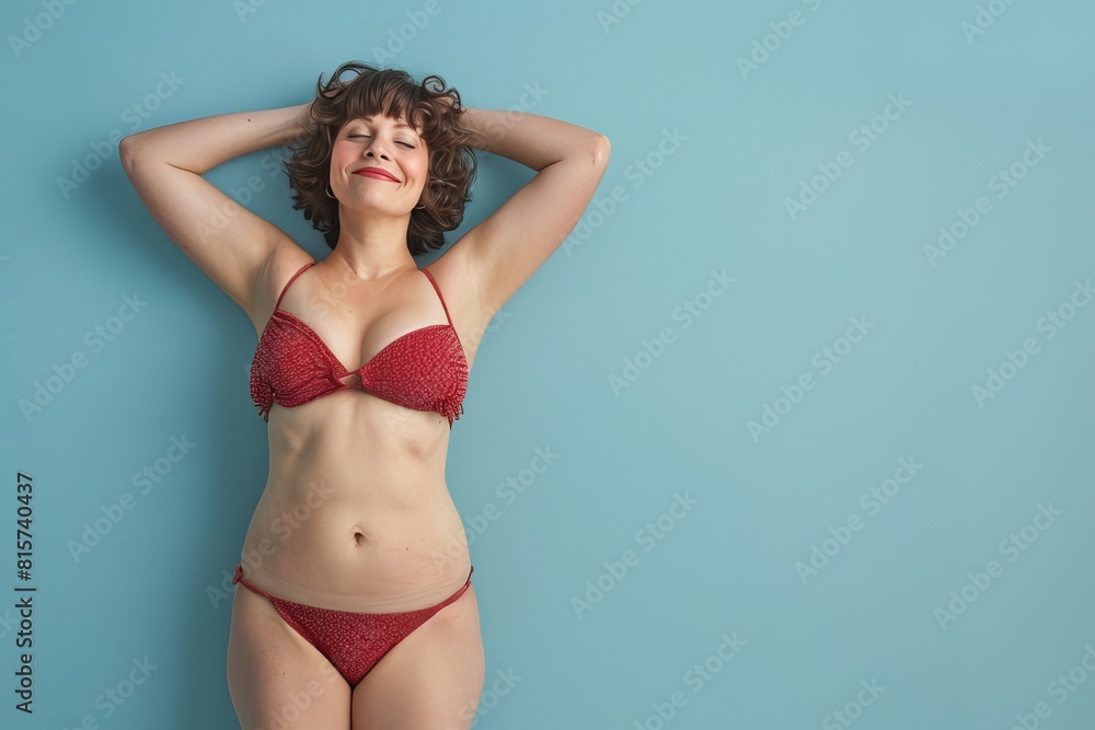 Woman in Red Bikini Poses on Blue Background Woman in Red Bikini Poses on Blue Background