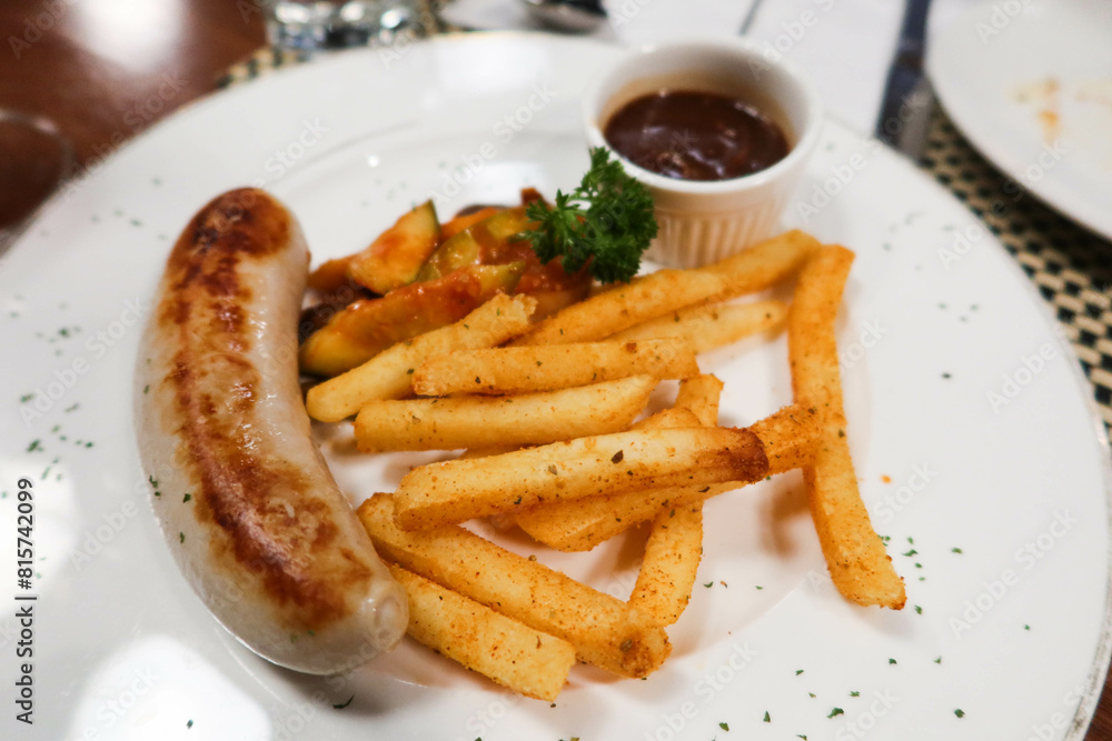 sausage and fries with sauce. A Switzerland style dish sausage and fries with sauce. A Switzerland style dish
