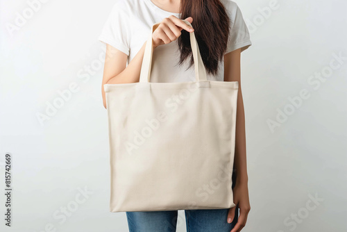 woman holding a blank canvas tote bag mock up