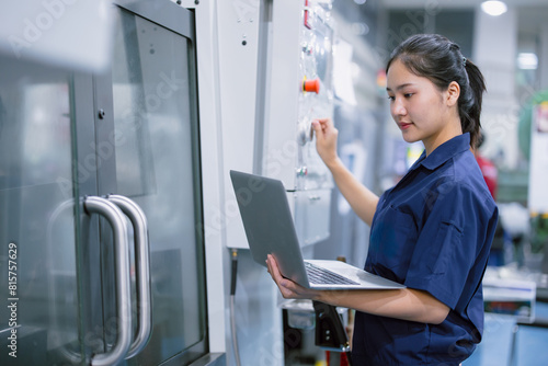 young technician engineer worker women working with CNC lathe metal machine in modern steel industry factory photo