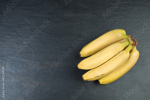 Bunch of bananas on a black background. Top view. photo