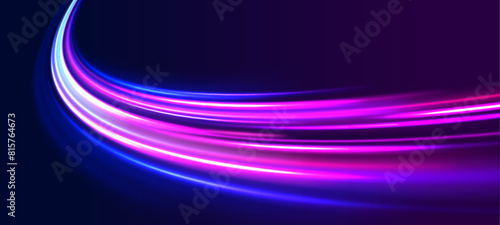 Light motion trails. High speed motion blurred light effects at night in blue and red colors. Glowing spark swirl trail tracing on dark blue background. Abstract light lines of movement and speed. 