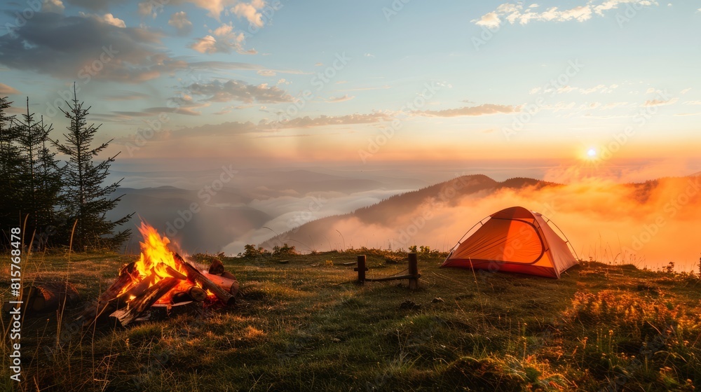 a camping on the hill. bonfire. fog. a morning sunrise