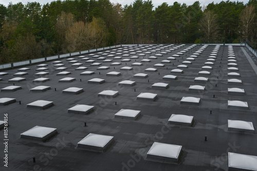 Top view of a modern roof with natural light. Skylights. Energy efficiency. Transparent panels on the roof.