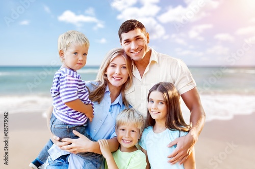 Happy family with children having fun on the beach