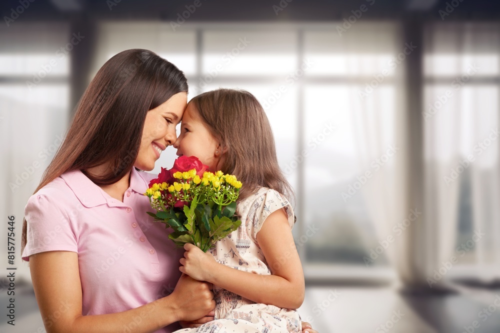 Happy Child daughter giving bouquet of flowers to mother Happy Child daughter giving bouquet of flowers to mother