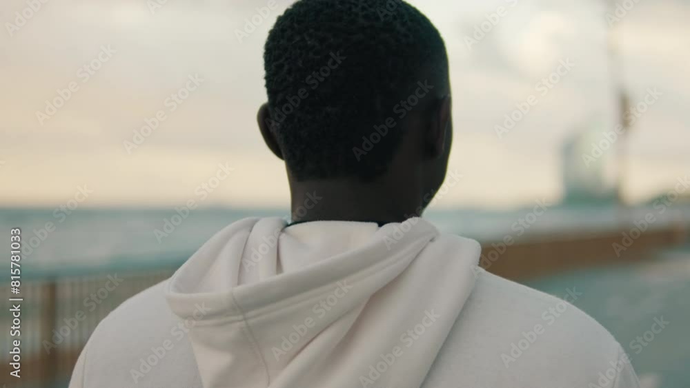 Back view of man walks in the evening in a beautiful southern city Back view of man walks in the evening in a beautiful southern city
