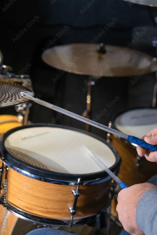 Close-up of drumsticks on drums in the hands of a drummer, selective focus. Vertical photo Close-up of drumsticks on drums in the hands of a drummer, selective focus. Vertical photo