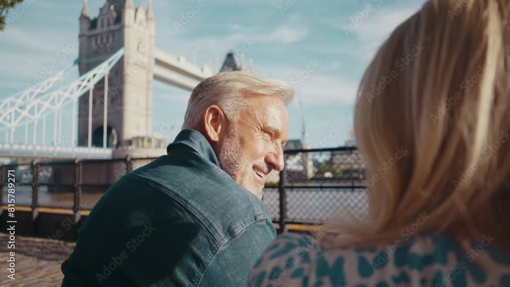 Happy senior couple spending time together in London city. Beautiful woman and man hugging while watching the Thames river. Concepts about seniority, lifestyle and travel Happy senior couple spending time together in London city. Beautiful woman and man hugging while watching the Thames river. Concepts about seniority, lifestyle and travel