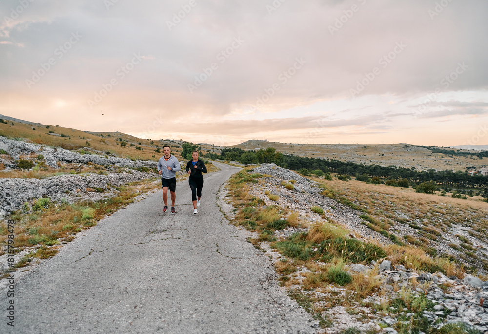 Fototapeta premium A Couple's Energizing Morning Run in the Mountains
