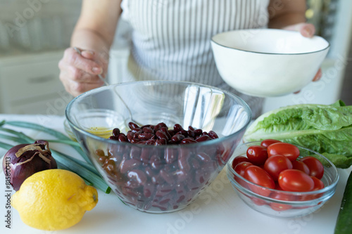 Woman preparing a fresh beans salad in the kitchen