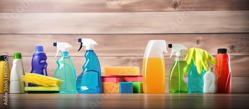 An advertisement for a cleaning company featuring cleaning products placed on a wooden background with copy space in the center of the image