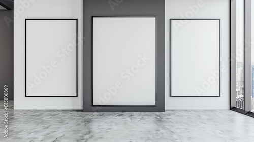 A modern gallery with a dramatic display of three oversized plain white frames  each overlapping the next in a layered fashion.
