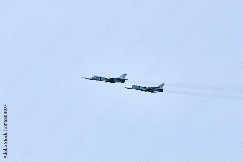 Two Russian military fighter planes armed with missiles flies in blue ...