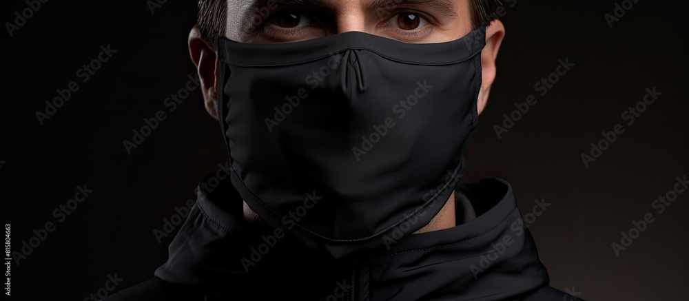 A face mask made of black protective fabric suitable for covering the nose and mouth allowing for a comfortable fit and providing adequate protection Ideal for situations where a copy space image is A face mask made of black protective fabric suitable for covering the nose and mouth allowing for a comfortable fit and providing adequate protection Ideal for situations where a copy space image is