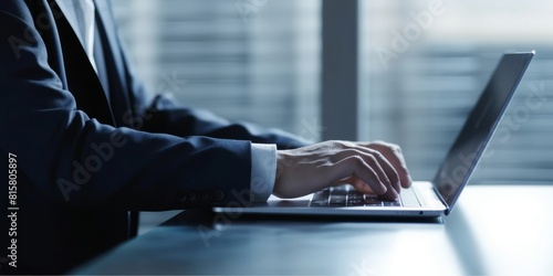Close up of Asian business man hand working using keyboard typing messages to colleagues and making financial information on computer laptop photo