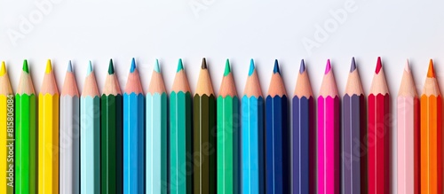 A white background showcases colorful pencils leaving ample copy space in the image