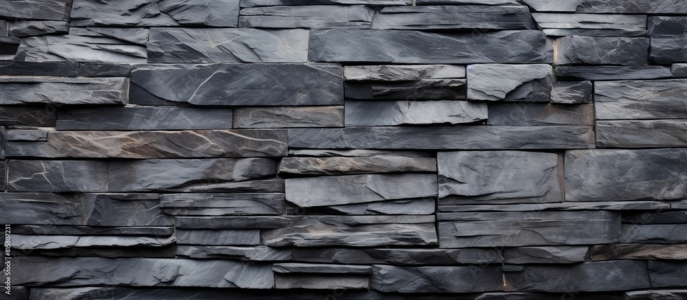A textured wall made of slate stone providing a background with a copy space image A textured wall made of slate stone providing a background with a copy space image