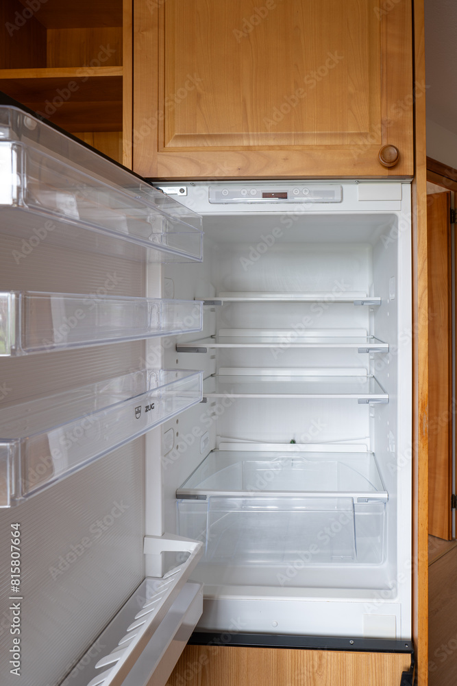 Open door home refrigerator with empty shelves, no people Open door home refrigerator with empty shelves, no people